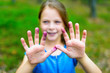 © bubutu - little girl is showing the blueberry-colored hands - smiling face and purple fingers - very shallow depth of field
