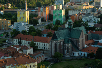 Wall Mural - View of the center of Brno Czech Republic houses church and street captured from the height of the walls of Spilberk Castle during sunset in summer time.