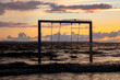 © Elena Sistaliuk - Swing on beautiful sunset sea and beach, Sweden, Helsingborg