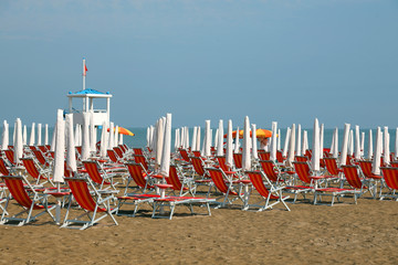 Wall Mural - sun umbrellas and deckchairs  on the sandy beach of the resort i