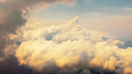 Wall Mural - Flying through heavenly beautiful cloudscape. Picturesque timelapse of warm tone fluffy clouds moving softly on the pale blue sky in the evening sunshine. Direct view from the cockpit.