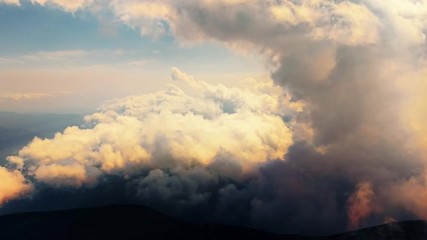 Wall Mural - Flying through heavenly beautiful cloudscape. Timelapse of warm tone fluffy clouds moving softly on the pale blue sky in the evening sunshine. View from the cockpit. 