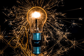 light bulb and sparkler in the dark