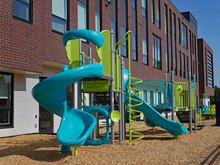 Large Brick School Building With Playground Equipment
