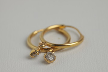 close up shot of gold ear ring on a white isolated background