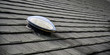 Dome shaped solar tube skylight on asphalt shingle roof 