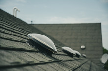 Dome Shaped Solar Tube Skylight On Asphalt Shingle Roof 