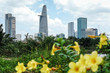 A different view of Ho Chi Minh City, Vietnam's modern skyline with green jungle landscape and flowers next to skyscrapers and high rise buildings