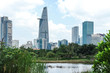 A different view of Ho Chi Minh City, Vietnam's modern skyline with green jungle landscape next to skyscrapers and high rise buildings