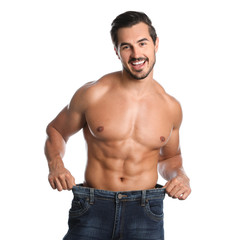 Wall Mural - Young man with slim body in old big size jeans on white background