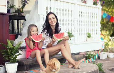 Young family eating a juicy red watermelon