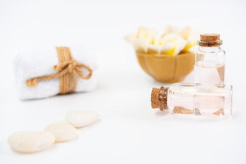 Spa concept,white towels,rose liquid soap,Plumeria flower and zen stone over white background, with space for text