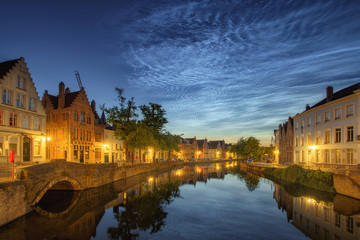 Wall Mural - Noctilucent clouds (night shining clouds) at city Bruges (Brugge) old town in Belgium in the dusk, Europe