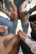 © fizkes - Closeup view people sitting together holding hands during therapy session