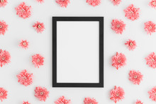 Top View Of A Black Frame Mockup With Pink Chrysanthemum Decoration On A White Background.