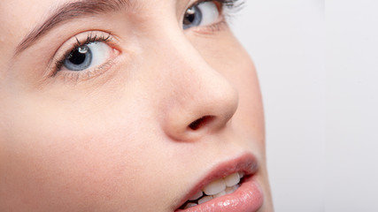 Close-up of a young girl and her blue eye