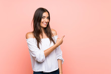 Young Woman Over Isolated Pink Background Pointing Back