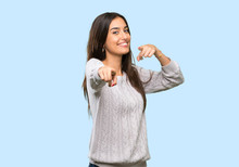 Young Hispanic Brunette Woman Points Finger At You While Smiling Over Isolated Background