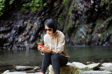 Wall Mural - Asian woman using mobile phone