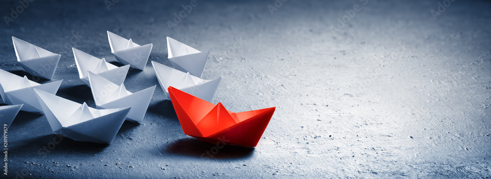 Red Leader Paper Boat Leading Group Of Paper Boates - obrazy, fototapety, plakaty 