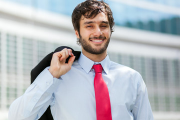 Wall Mural - Smiling businessman portrait holding his jacket