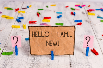 Conceptual hand writing showing Hello I Am New. Concept meaning used as greeting or to begin telephone conversation Crumbling sheet with paper clips placed on the wooden table