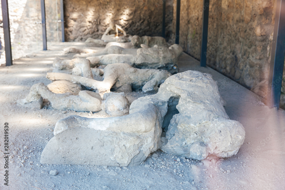 Plaster cast bodies of the victims at the ancient city of Pompeii - obrazy, fototapety, plakaty 