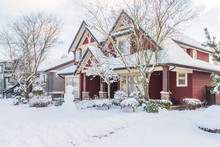A Typical American House In Winter. Snow Covered.