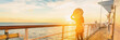 Cruise ship luxury vacation travel elegant woman watching sunset over Caribbean sea on deck boat summer tourist destination panoramic banner.