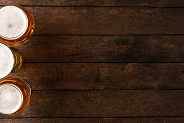 Beer glasses on wooden table with copyspace.