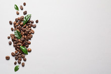 Fresh Green Coffee Leaves And Beans On Light Background, Flat Lay. Space For Text