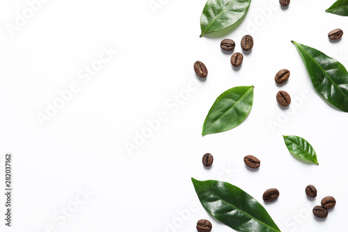 Fotografía Fresh green coffee leaves and beans on white background, top view