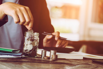 Wall Mural - asian man working with calculator to calculate numbers. expenses calculator, payments costs with paper notes, payments table. Financial and Installment payment concept. Saving concept - Image