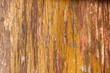 scratched grungy wooden desk flooring with lacquer and yellow paint peeled off. Grubby wooden surface with peeling paint, texture with copy space for text.