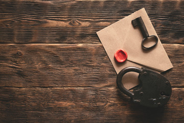Wall Mural - top secret documents in envelope, rusty padlock and a key on a wooden table flat lay background. con