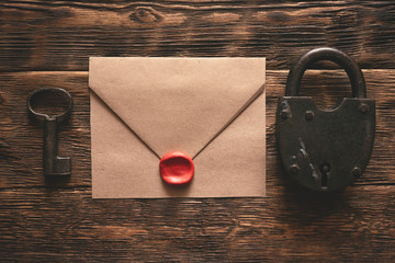 Wall Mural - top secret documents in envelope, rusty padlock and a key on a wooden table flat lay background. con