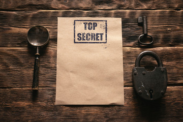 Wall Mural - top secret document with a confidential information mockup on a wooden table flat lay background.