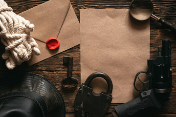 Wall Mural - top secret information mockup, leather hat, weapon, magnifying glass and rope on a wooden table of s