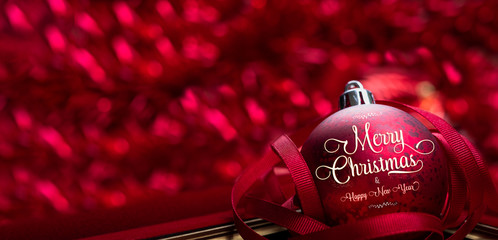 Poster - Merry christmas and happy new year red background.close up red decoration ball with blur tinsel at background.holiday celebration greeting card.banner panoramic mockup for display of design.