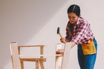 Wall Mural - woman worker in the carpenter workroom.