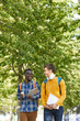 © Seventyfour - Portrait of two international college students chatting cheerfully while walking to school, copy space