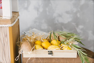 Wall Mural - yellow lemons lie in a wooden box, copy space