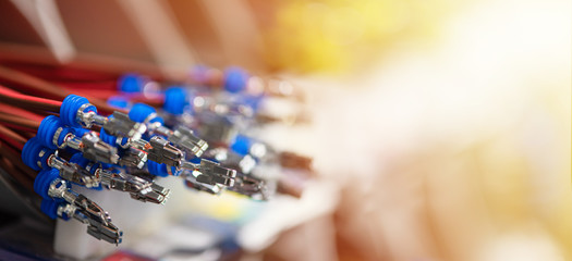 Bundle of crimped cables with electrical connectors. Terminated wire ready to creation connection. Industrial background with copy space for text, soft color effect