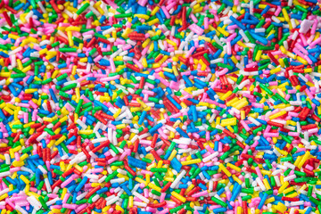 Colorful candy sprinkles close up for birthday cake on white background