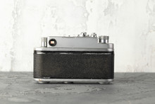 The Old Rangefinder Film Camera With On Grey Cement Background.