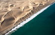 © Kertu - Aerial view of Skeleton coast sand dunes meeting the waves of Atlanic ocean. Skeleton coast, Namibia.