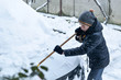 © Ivan - Teenager removing snow with a shovel in the winter