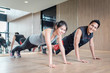 © interstid - Asian couple doing push up together in fitness gym