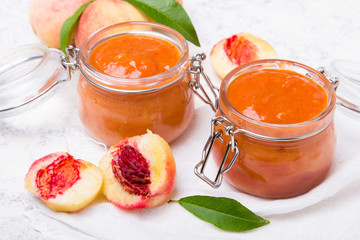 Wall Mural - Homemade peach jam with organic fruit. Sweet preserves on a light background