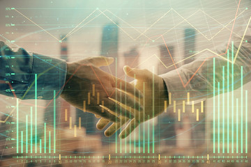 Double exposure of financial graph on cityscape background with two businessman handshake. Concept of stock market deal